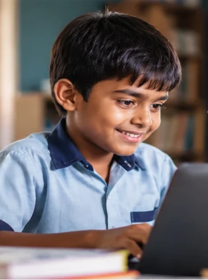 A smiling student learning on a laptop